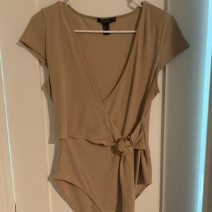 Gorgeous tan bodysuit with adjustable side tie. Wear it to work or girls night!
